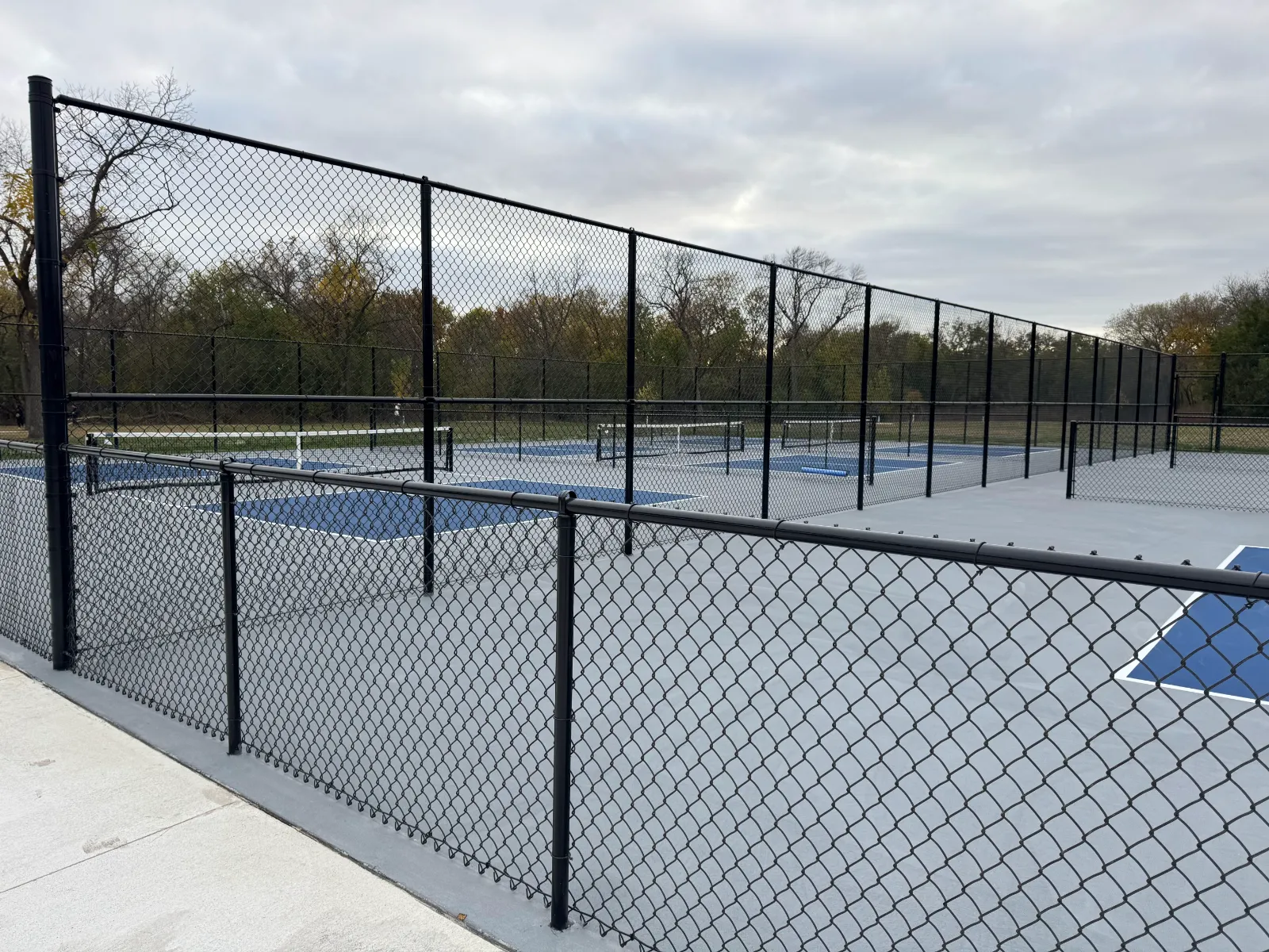 Custom athletic pickleball court chain link enclosure installation