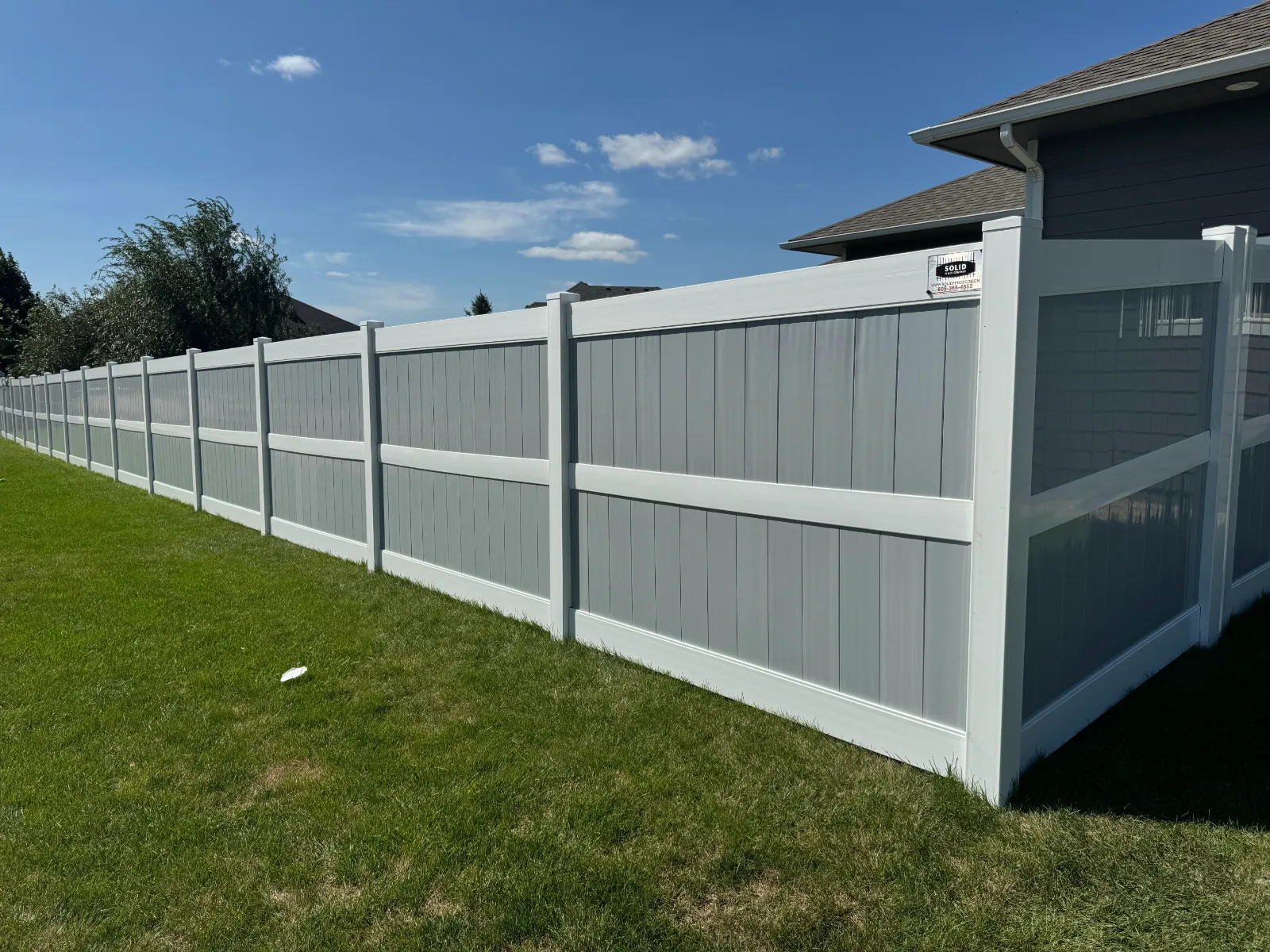 Clean white vinyl privacy backyard fence